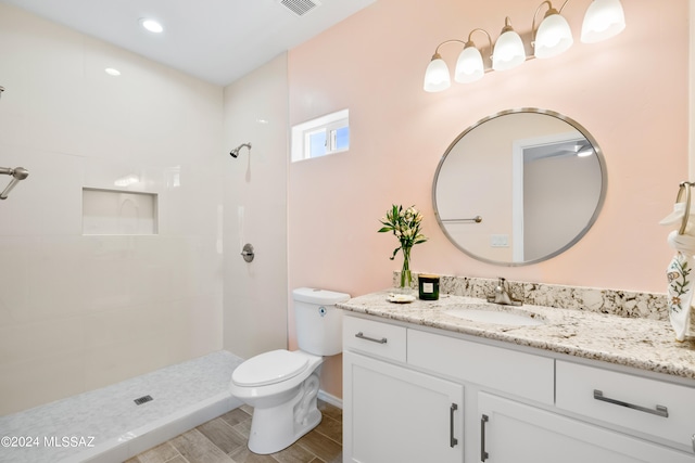 bathroom featuring vanity, toilet, walk in shower, and hardwood / wood-style floors