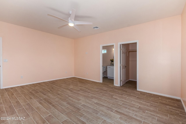 unfurnished room with light wood-type flooring and ceiling fan