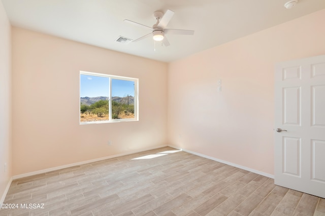 spare room featuring ceiling fan and light wood-type flooring