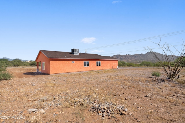 back of house featuring cooling unit and a mountain view