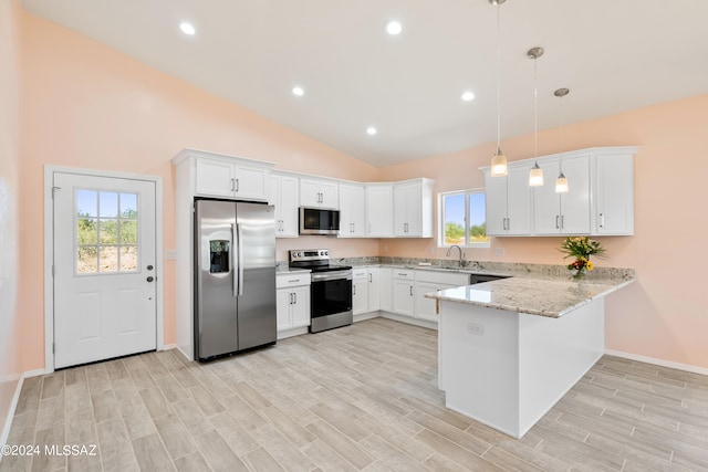 kitchen with plenty of natural light, kitchen peninsula, appliances with stainless steel finishes, and pendant lighting