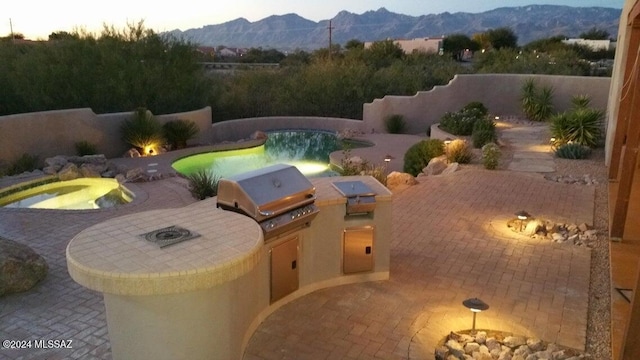 view of patio with a mountain view and area for grilling