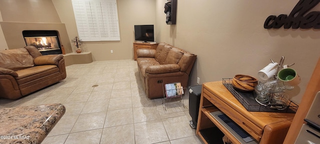 tiled living room with a multi sided fireplace