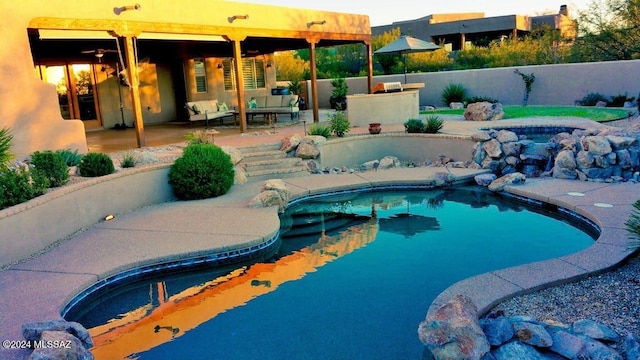 view of pool with an outdoor living space and a patio area