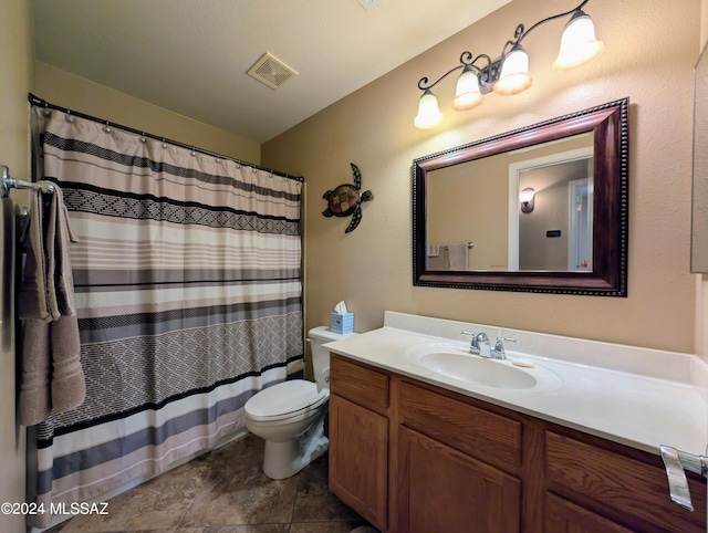 bathroom with a shower with curtain, tile patterned floors, vanity, and toilet