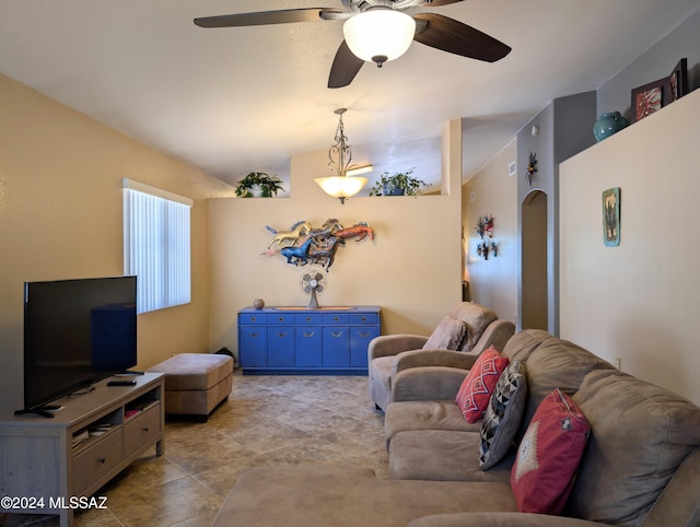 living room with ceiling fan, light tile patterned flooring, and vaulted ceiling