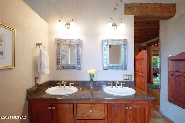 bathroom featuring beam ceiling, tile patterned floors, and vanity