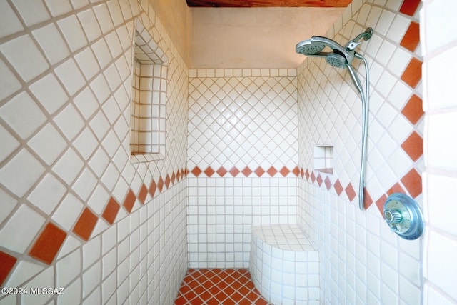 bathroom with tile walls and a shower