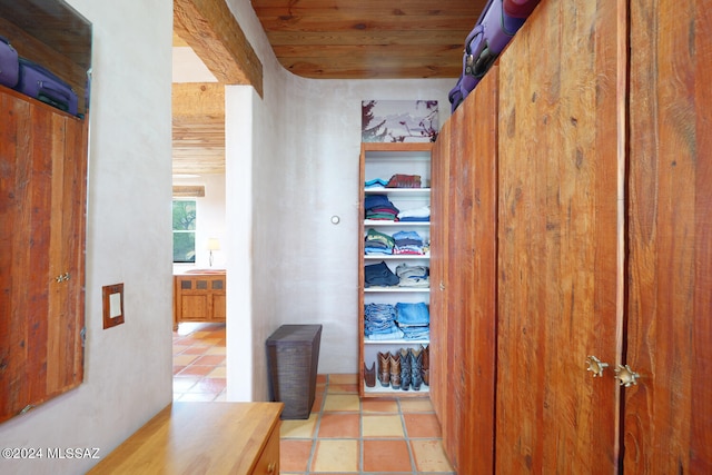 corridor featuring a barn door and light tile patterned floors