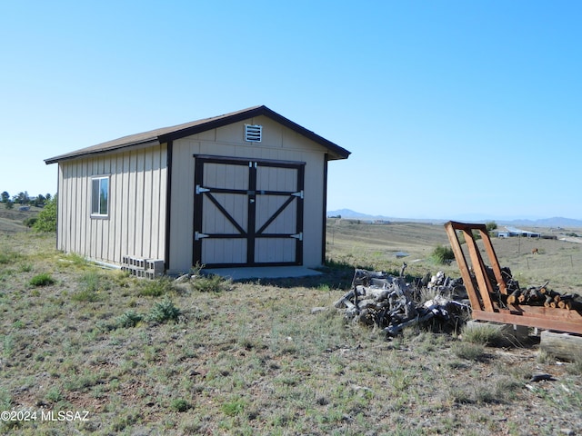 view of outbuilding featuring a mountain view