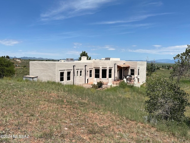 back of house featuring a mountain view