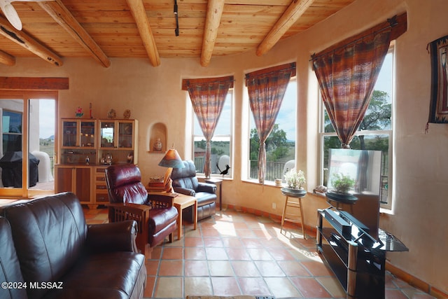 tiled living room featuring a healthy amount of sunlight, beam ceiling, and wooden ceiling