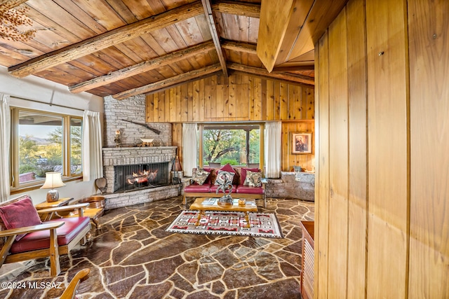 living room featuring a fireplace, wooden ceiling, lofted ceiling with beams, and wooden walls