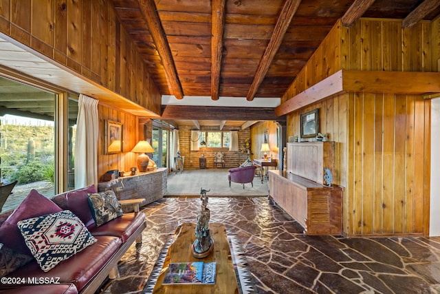 living room with wooden walls, beam ceiling, and wooden ceiling