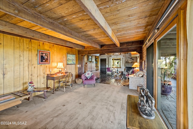 interior space featuring beamed ceiling, wooden walls, plenty of natural light, and wooden ceiling