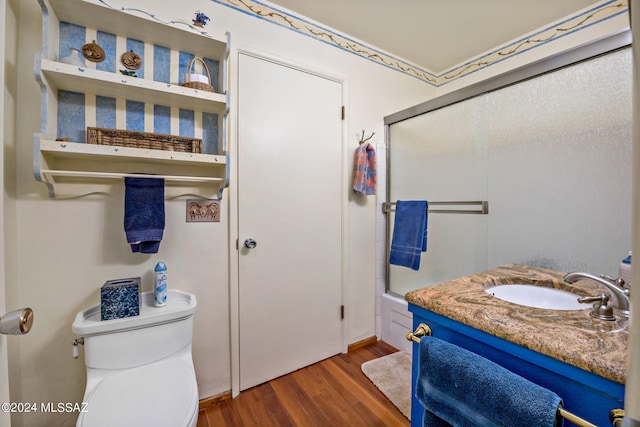 full bathroom featuring wood-type flooring, vanity, toilet, and combined bath / shower with glass door