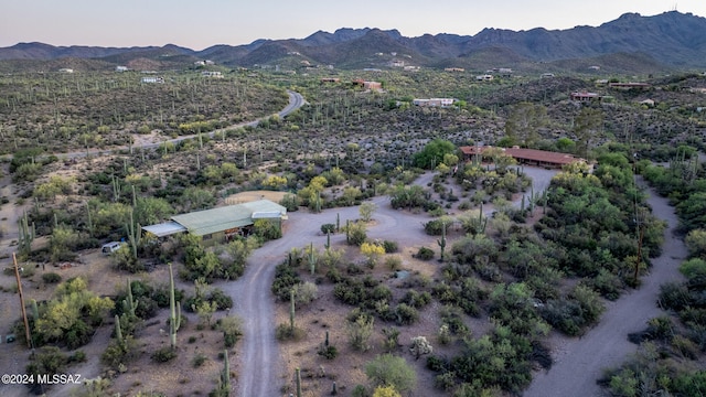 aerial view at dusk featuring a mountain view