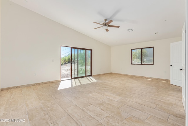 spare room featuring a wealth of natural light, vaulted ceiling, and ceiling fan