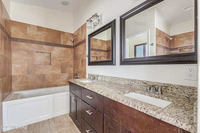 bathroom featuring vanity, tiled shower / bath, and tile patterned flooring