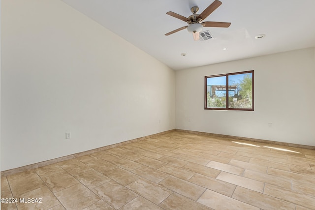 spare room with vaulted ceiling and ceiling fan