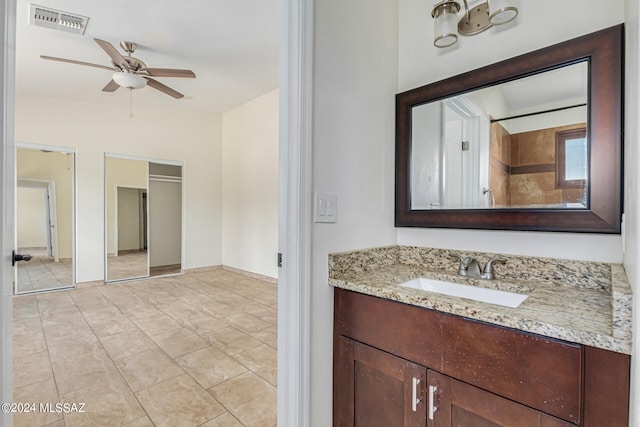 bathroom featuring vanity, ceiling fan, walk in shower, and tile patterned flooring