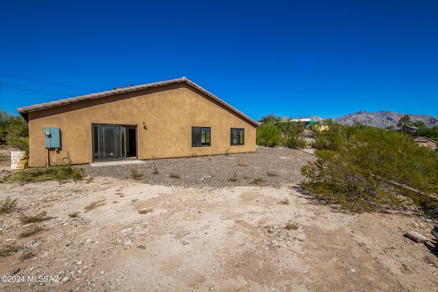 back of house with a mountain view