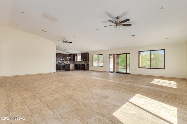 unfurnished living room featuring vaulted ceiling and ceiling fan