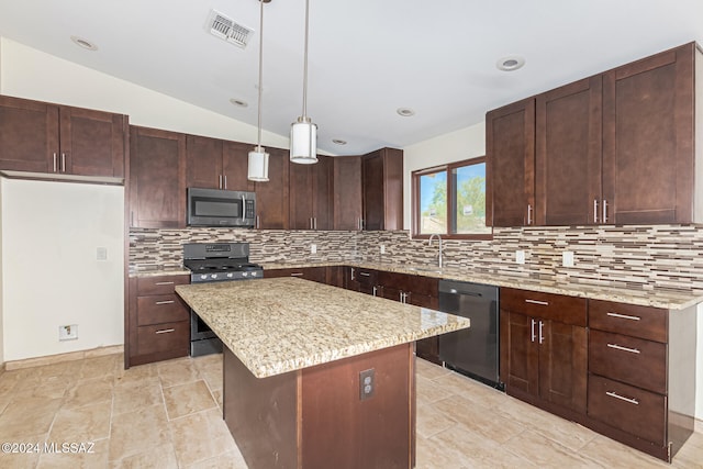 kitchen with tasteful backsplash, a center island, hanging light fixtures, stainless steel appliances, and vaulted ceiling