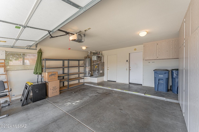 garage featuring a garage door opener and water heater