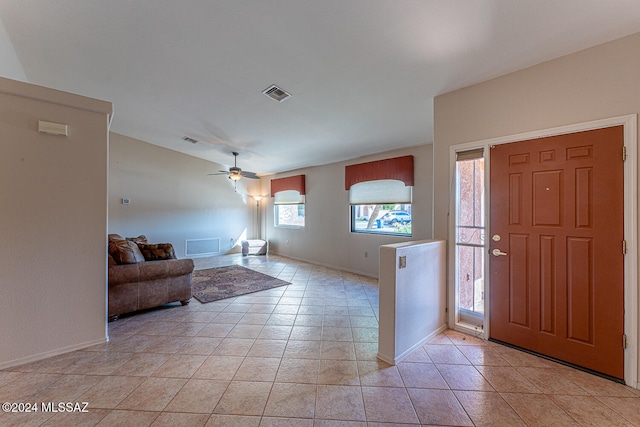 tiled foyer featuring ceiling fan