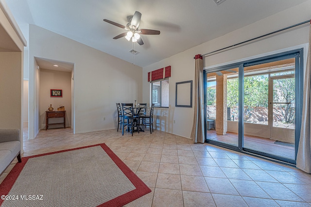 unfurnished living room featuring light tile patterned floors, vaulted ceiling, and ceiling fan