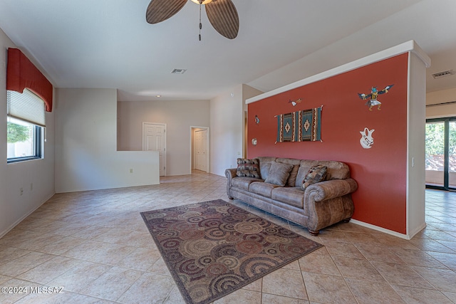 living room featuring light tile patterned floors and ceiling fan