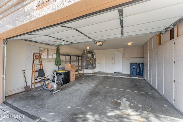 garage featuring gas water heater and a garage door opener