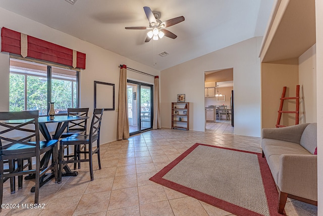 tiled dining area featuring vaulted ceiling and ceiling fan with notable chandelier