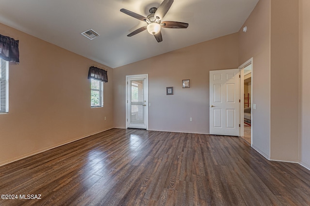 spare room with ceiling fan, dark hardwood / wood-style flooring, and lofted ceiling