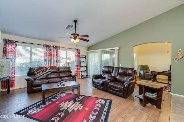 living room with ceiling fan, vaulted ceiling, and light hardwood / wood-style floors