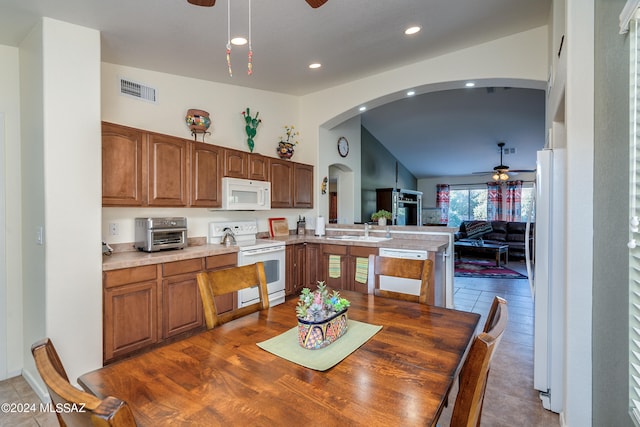 kitchen with lofted ceiling, white appliances, sink, and dark hardwood / wood-style flooring