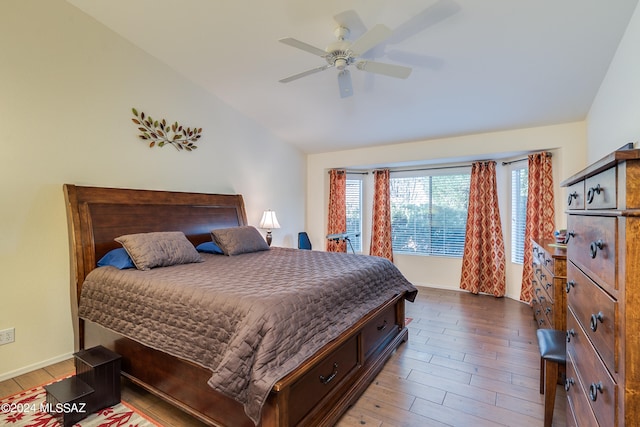 bedroom featuring lofted ceiling, hardwood / wood-style flooring, and ceiling fan