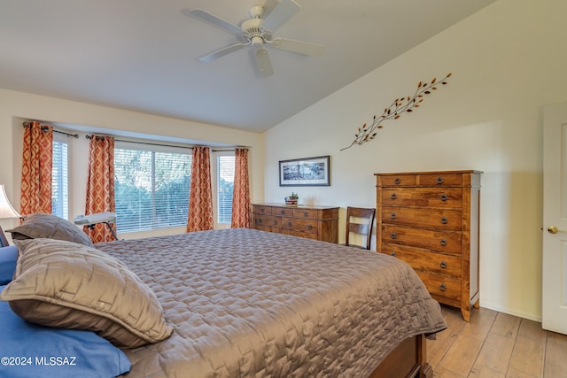 bedroom with lofted ceiling, ceiling fan, and light hardwood / wood-style flooring