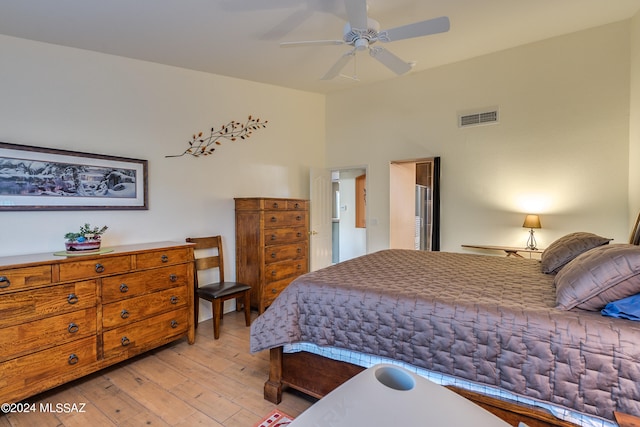 bedroom with ceiling fan and light hardwood / wood-style flooring