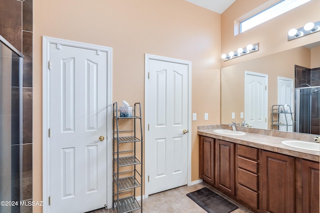 bathroom featuring tile patterned flooring, an enclosed shower, and vanity