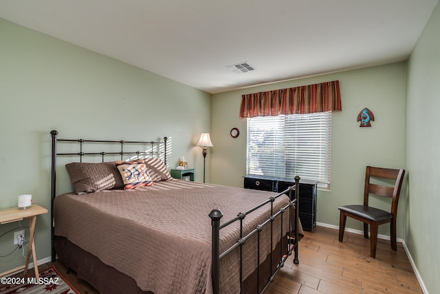 bedroom with hardwood / wood-style flooring