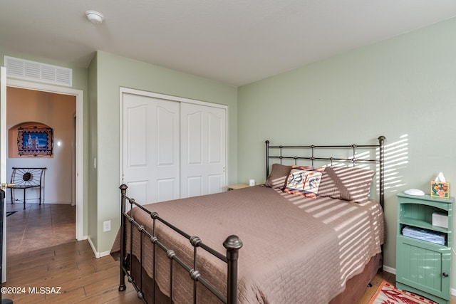 bedroom featuring hardwood / wood-style flooring and a closet