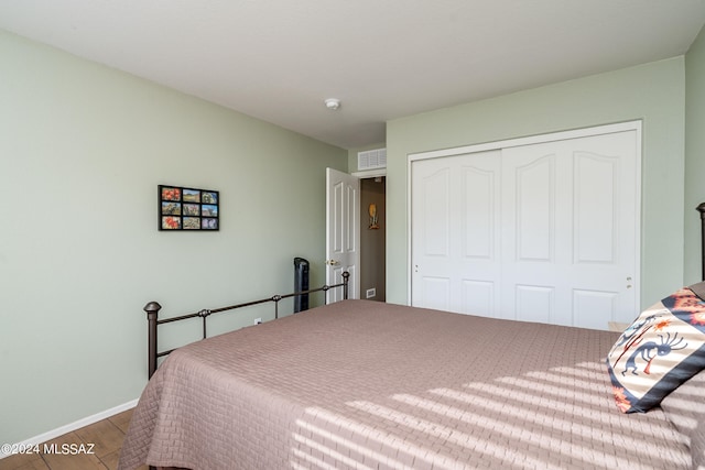 bedroom featuring wood-type flooring and a closet