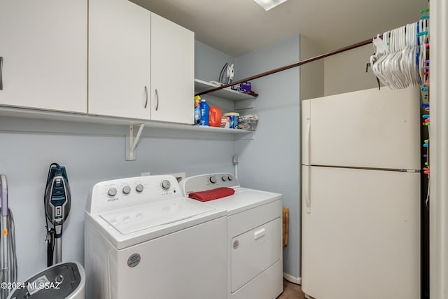 laundry area featuring independent washer and dryer and cabinets