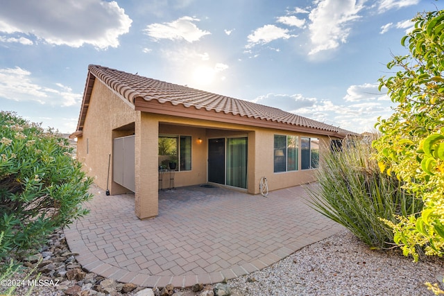 back of property with a patio