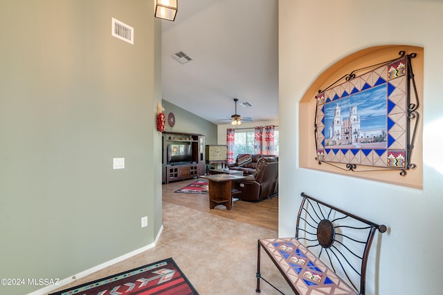 interior space featuring ceiling fan, lofted ceiling, and light hardwood / wood-style flooring