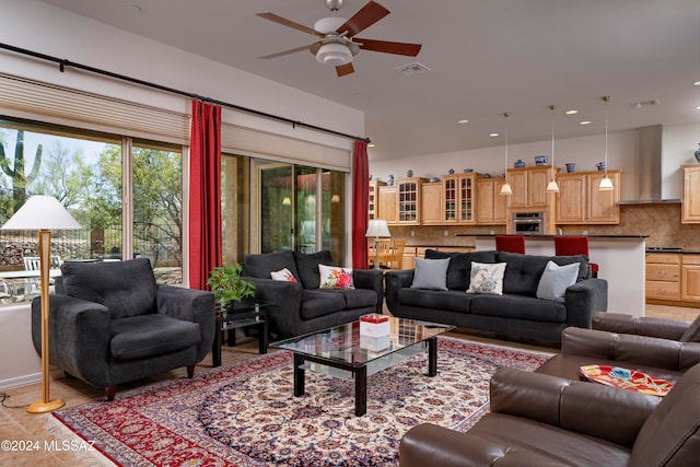 living room featuring light tile patterned floors and ceiling fan