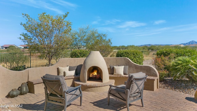 view of patio / terrace with a mountain view and an outdoor fireplace