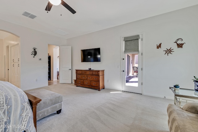 bedroom featuring ceiling fan, light carpet, and access to exterior